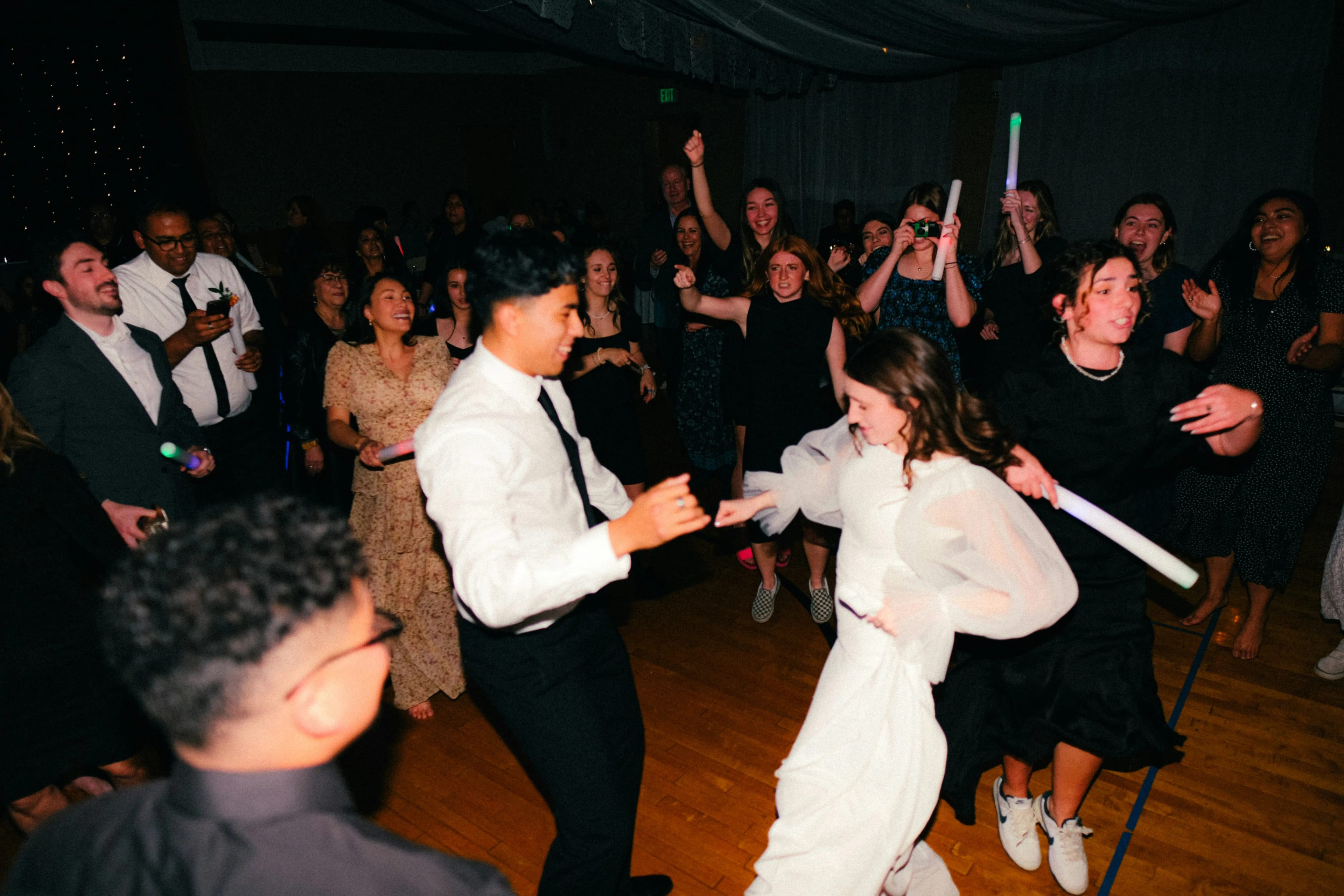 Bride and groom sharing a wedding photo album with their guests on Playlog